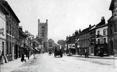Horse and carts travel along a quiet (compared to Henley traffic nowadays) Hart Street with the familiar sight of   Saint Mary's Church   in the distance.